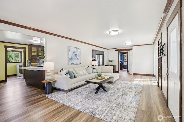 3718 NE Everett St, Camas, WA 98607 - living room featuring light wood-style flooring, baseboards, and ornamental molding