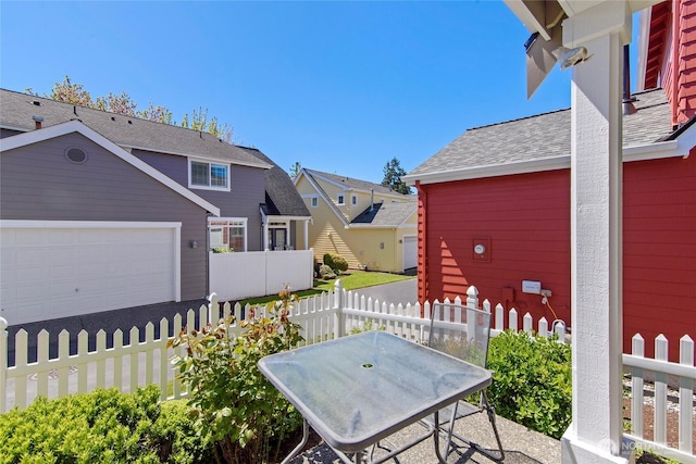 view of patio featuring fence and a residential view