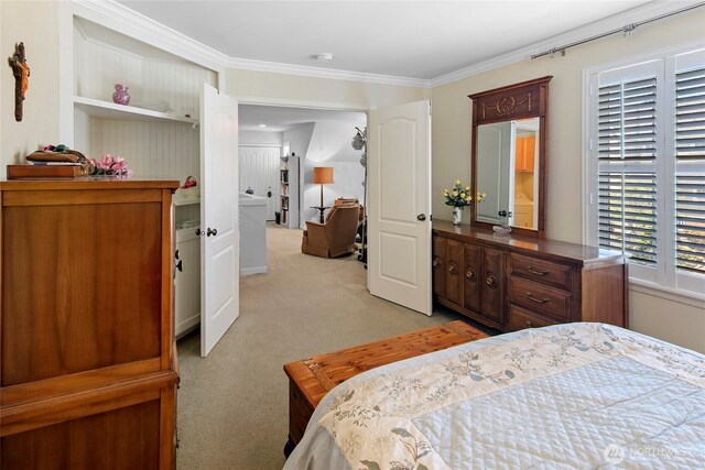 bedroom with light colored carpet and crown molding