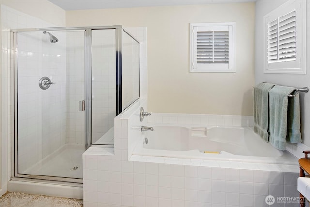 bathroom featuring a shower stall and a garden tub
