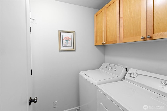 laundry room featuring cabinet space and washer and clothes dryer