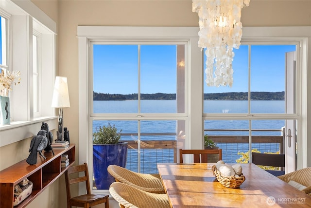 10915NE S Beach Rd, Bainbridge Island, WA 98110 - dining area featuring a water view, healthy amount of natural light, and a chandelier