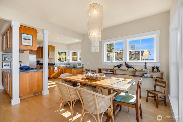 10915NE S Beach Rd, Bainbridge Island, WA 98110 - dining space with light wood-style flooring, recessed lighting, a chandelier, and decorative columns