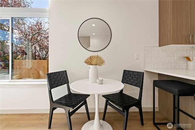 dining space featuring baseboards and wood finished floors