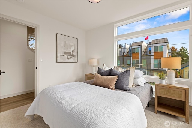 bedroom featuring wood finished floors and baseboards