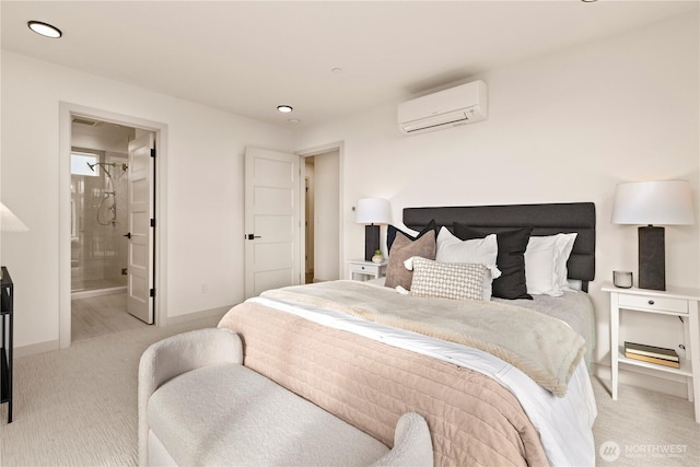 bedroom featuring ensuite bathroom, recessed lighting, light carpet, an AC wall unit, and baseboards