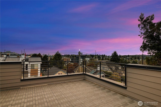 patio terrace at dusk with a balcony