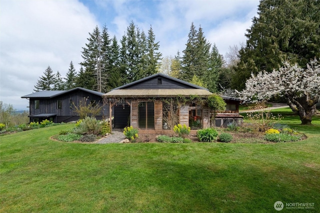 rear view of property featuring a lawn