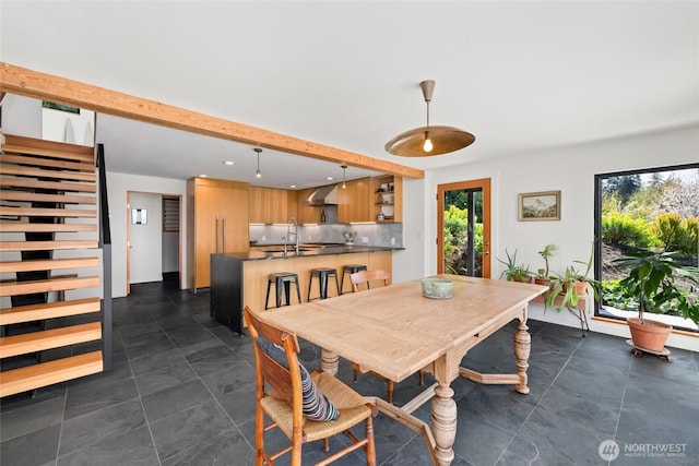 dining space featuring recessed lighting and beamed ceiling