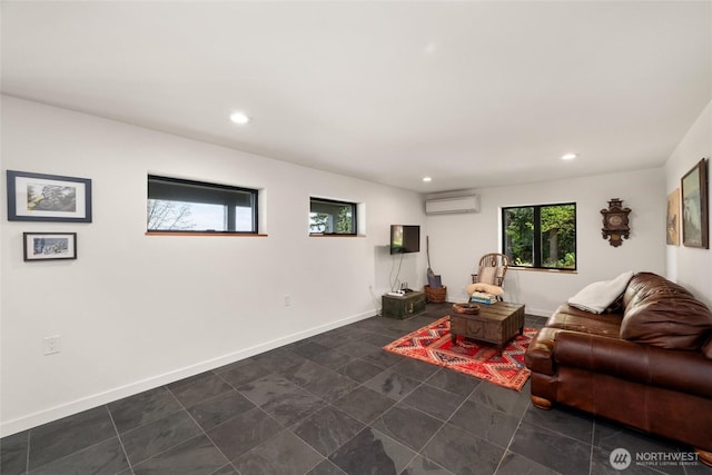 living room with a wall unit AC, baseboards, and recessed lighting