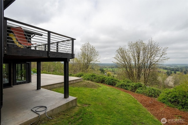 view of yard with a patio area and a wooden deck