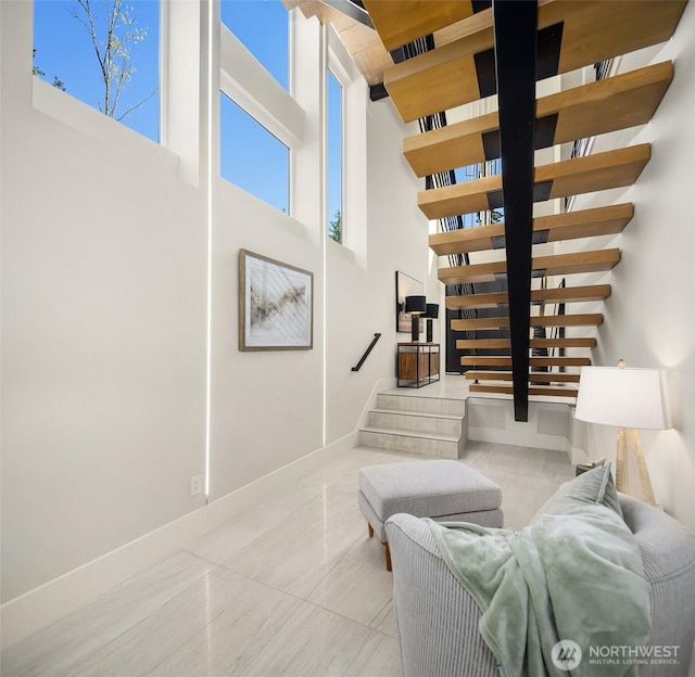 11896 SE 5th St, Bellevue, WA 98805 - living room with baseboards, stairway, and a towering ceiling