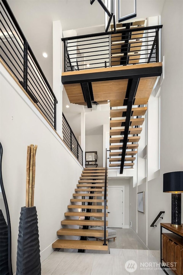 11896 SE 5th St, Bellevue, WA 98805 - staircase with baseboards and a towering ceiling