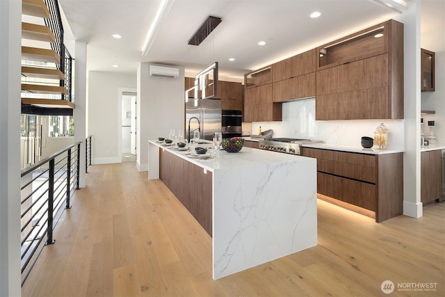 11896 SE 5th St, Bellevue, WA 98805 - kitchen featuring a wall unit AC, brown cabinetry, modern cabinets, light wood finished floors, and stainless steel appliances