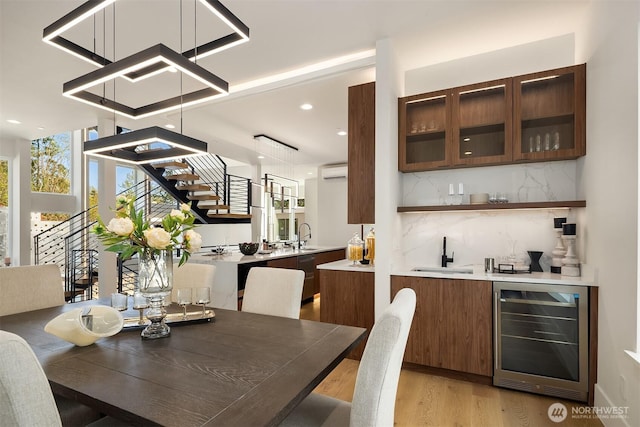 11896 SE 5th St, Bellevue, WA 98805 - dining space with wine cooler, indoor wet bar, recessed lighting, light wood-type flooring, and a wall unit AC