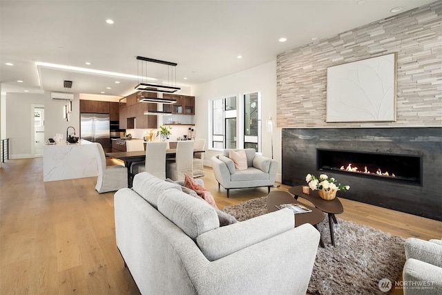 11896 SE 5th St, Bellevue, WA 98805 - living area with a fireplace, an AC wall unit, recessed lighting, and light wood-style flooring