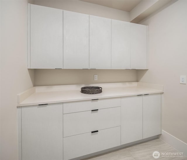 11896 SE 5th St, Bellevue, WA 98805 - kitchen with baseboards, light countertops, white cabinetry, and modern cabinets