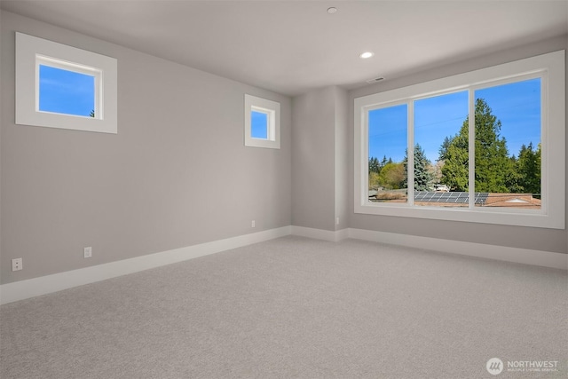 empty room with light carpet, baseboards, and recessed lighting