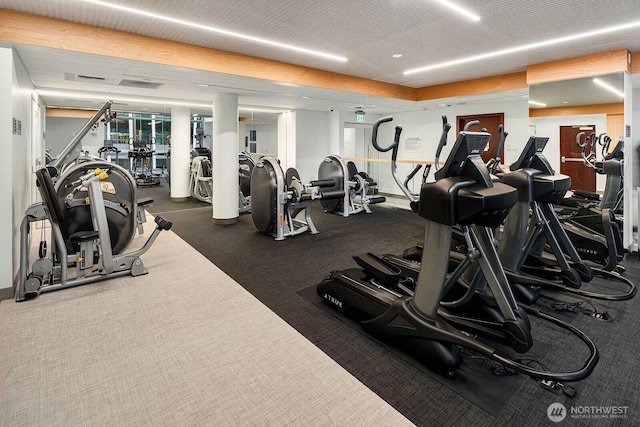 exercise room featuring dark carpet