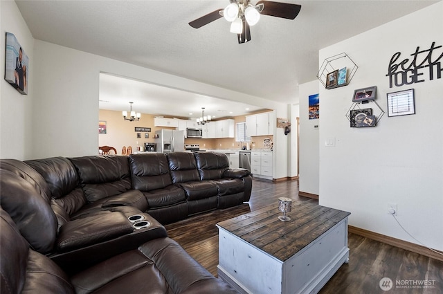 804 S Adams Ave, Warden, WA 98857 - living room with ceiling fan with notable chandelier, dark wood-style flooring, and baseboards