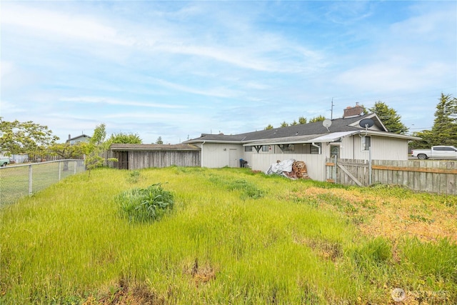 9941 Old Olympic Hwy, Sequim, WA 98382 - back of property featuring a fenced backyard and a chimney