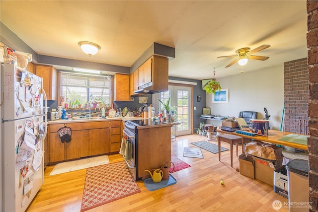 9941 Old Olympic Hwy, Sequim, WA 98382 - kitchen featuring freestanding refrigerator, stainless steel range with electric cooktop, light wood finished floors, brown cabinetry, and a ceiling fan
