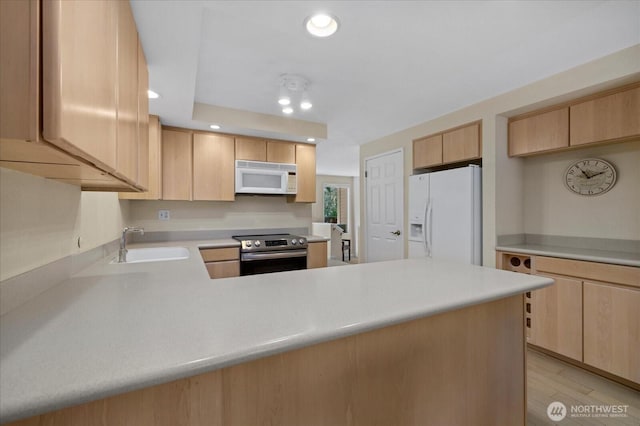 16972 65th Ln NE, Kenmore, WA 98028 - kitchen with light brown cabinets, a sink, light countertops, white appliances, and a peninsula