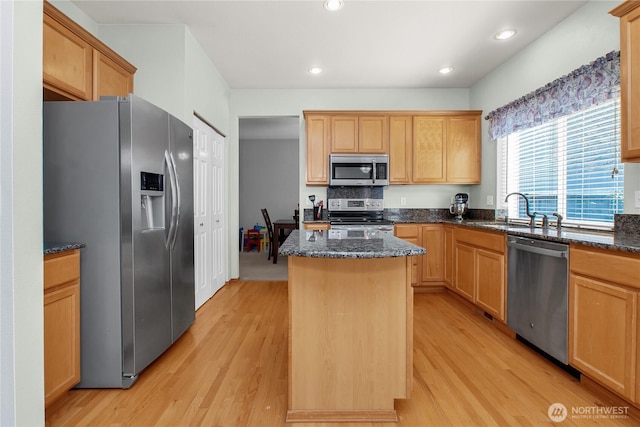 2825 Haig Dr SE, Olympia, WA 98501 - kitchen featuring a sink, a center island, appliances with stainless steel finishes, and light wood finished floors