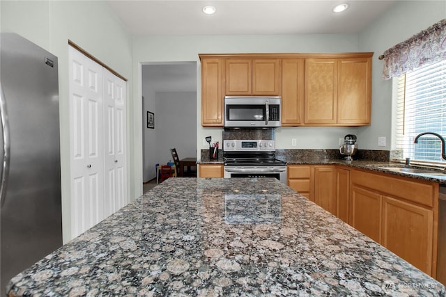 2825 Haig Dr SE, Olympia, WA 98501 - kitchen with dark stone countertops, appliances with stainless steel finishes, a sink, and recessed lighting