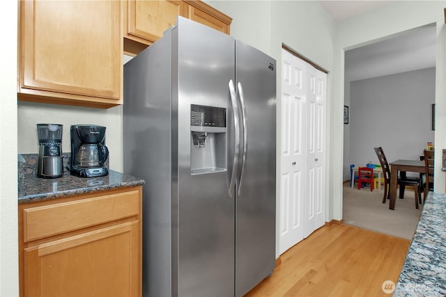 2825 Haig Dr SE, Olympia, WA 98501 - kitchen with stainless steel fridge with ice dispenser, light wood-style floors, and dark stone counters