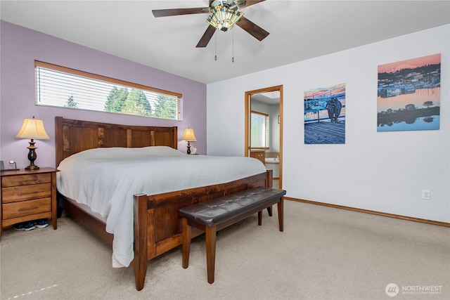 2825 Haig Dr SE, Olympia, WA 98501 - bedroom featuring light carpet, baseboards, a ceiling fan, and connected bathroom