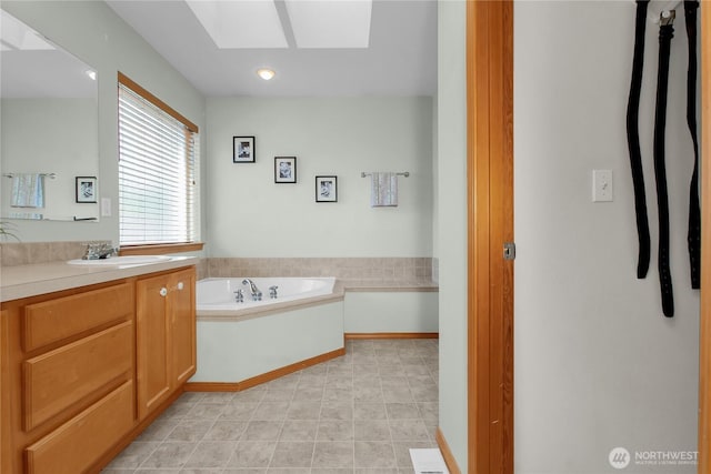 2825 Haig Dr SE, Olympia, WA 98501 - bathroom with a skylight, vanity, and a garden tub