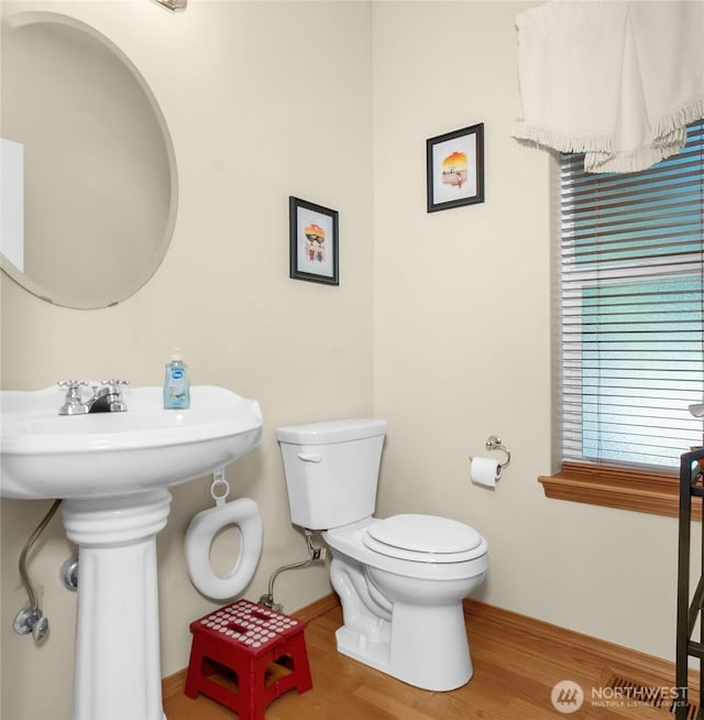 2825 Haig Dr SE, Olympia, WA 98501 - half bathroom with baseboards, a sink, toilet, and wood finished floors