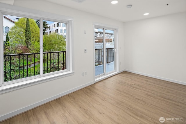 711 N 35th St, Seattle, WA 98103 - unfurnished room with wood finished floors, baseboards, and recessed lighting