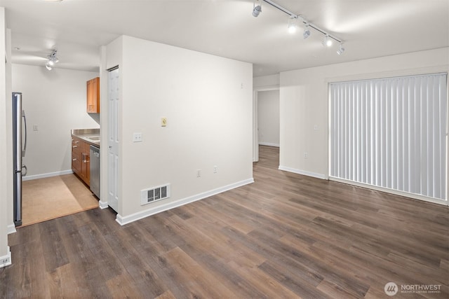 711 N 35th St, Seattle, WA 98103 - unfurnished living room featuring dark wood-style floors, visible vents, baseboards, and track lighting