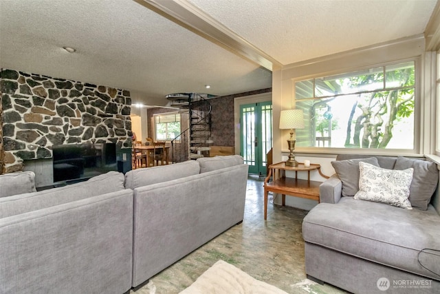 living area featuring concrete flooring and a textured ceiling