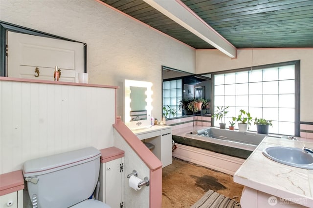 full bath featuring wood ceiling, a garden tub, vanity, toilet, and concrete floors