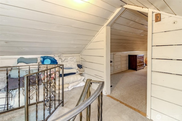 bonus room featuring carpet floors, wood walls, wooden ceiling, and lofted ceiling