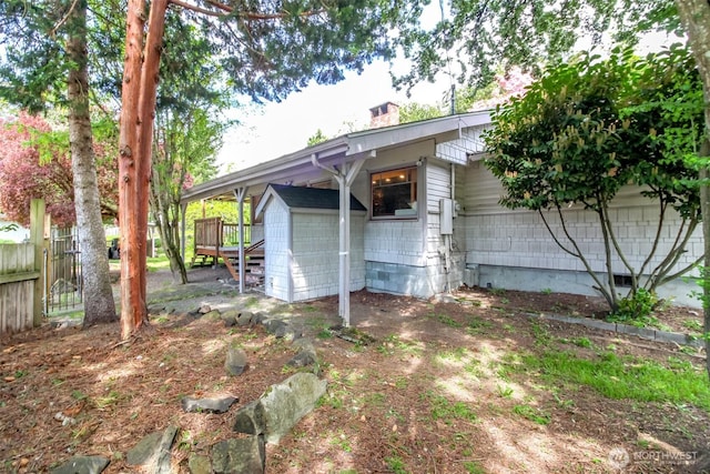 view of shed featuring fence