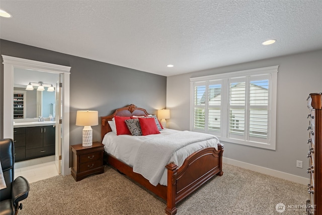 4407 N Ridgefield Woods Dr, Ridgefield, WA 98642 - bedroom featuring a textured ceiling, recessed lighting, baseboards, ensuite bathroom, and light carpet