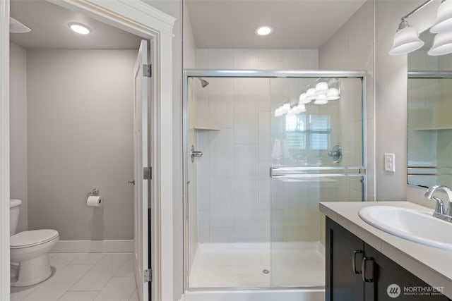 4407 N Ridgefield Woods Dr, Ridgefield, WA 98642 - full bathroom with tile patterned flooring, toilet, vanity, a stall shower, and recessed lighting