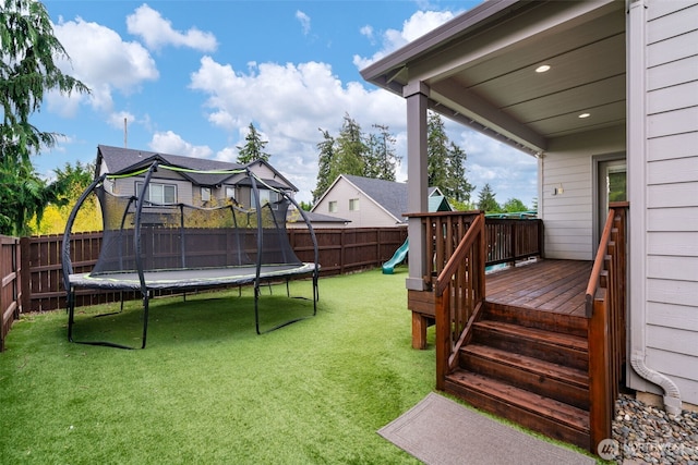 4407 N Ridgefield Woods Dr, Ridgefield, WA 98642 - view of yard with a trampoline, a playground, and a deck