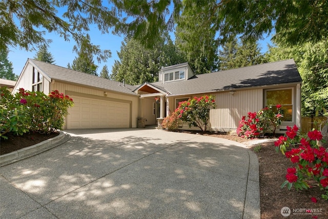 mid-century home with an attached garage and concrete driveway