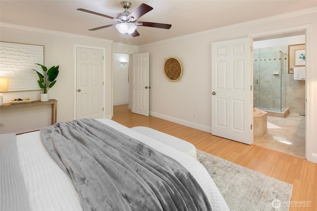 bedroom featuring wood finished floors, ornamental molding, ensuite bath, ceiling fan, and baseboards