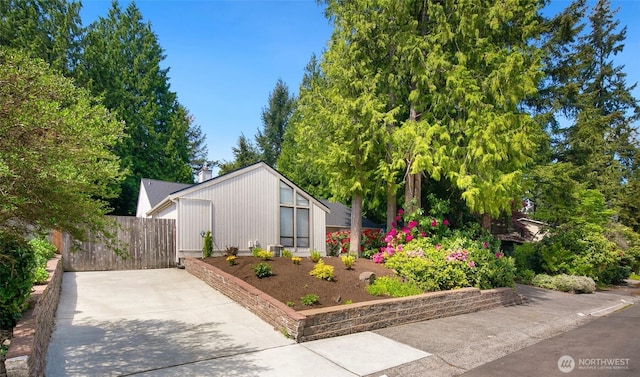 view of home's exterior with fence and a chimney