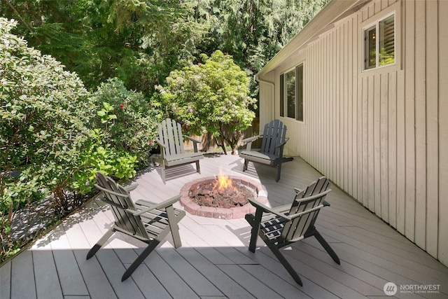 wooden deck with an outdoor fire pit