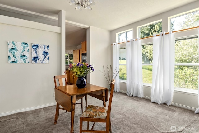 4592 Evenstar Ln, Freeland, WA 98249 - dining room with light colored carpet, a chandelier, and baseboards