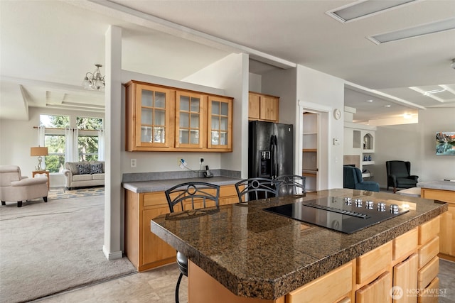 4592 Evenstar Ln, Freeland, WA 98249 - kitchen featuring open floor plan, tile countertops, black appliances, glass insert cabinets, and a center island