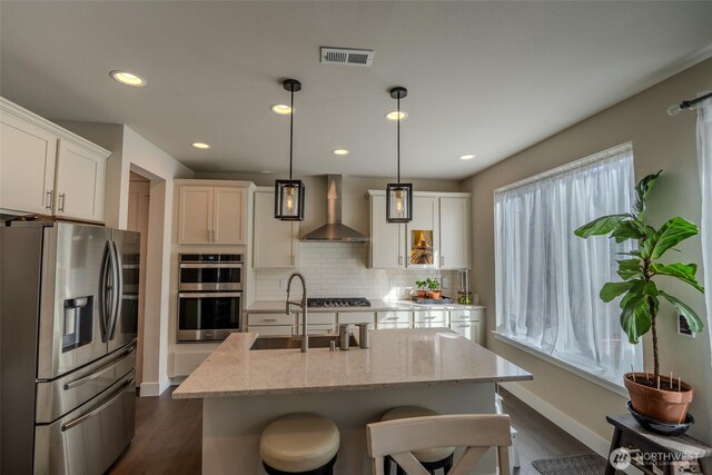 29027 NE 156th St, Duvall, WA 98019 - kitchen featuring visible vents, dark wood-style floors, wall chimney exhaust hood, and stainless steel appliances