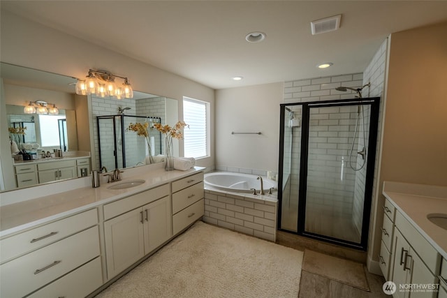 29027 NE 156th St, Duvall, WA 98019 - full bath with visible vents, a bath, a sink, a shower stall, and two vanities